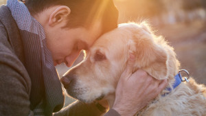 Man embracing his faithful friend the dog